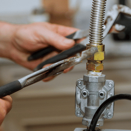 close-up of a worker repairing a gas line